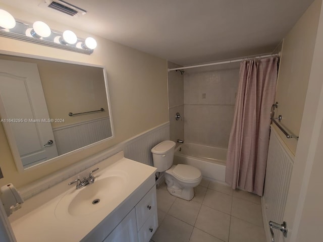 full bathroom featuring tile patterned floors, shower / bath combo, toilet, and vanity