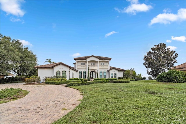 mediterranean / spanish home featuring a front yard