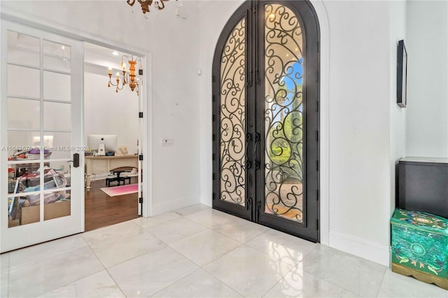 foyer with a chandelier and french doors