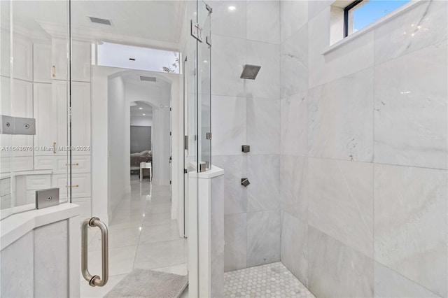 bathroom with tile walls, tile patterned flooring, and an enclosed shower