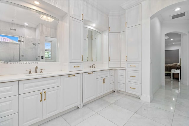 bathroom featuring a shower with shower door, ornamental molding, and vanity