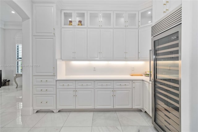 kitchen with white cabinetry, wine cooler, and ornamental molding