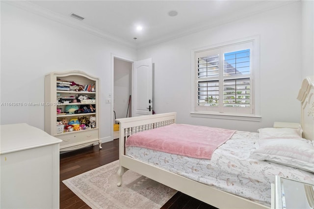 bedroom with crown molding and dark hardwood / wood-style floors