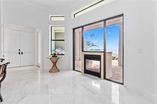 entrance foyer featuring ornamental molding