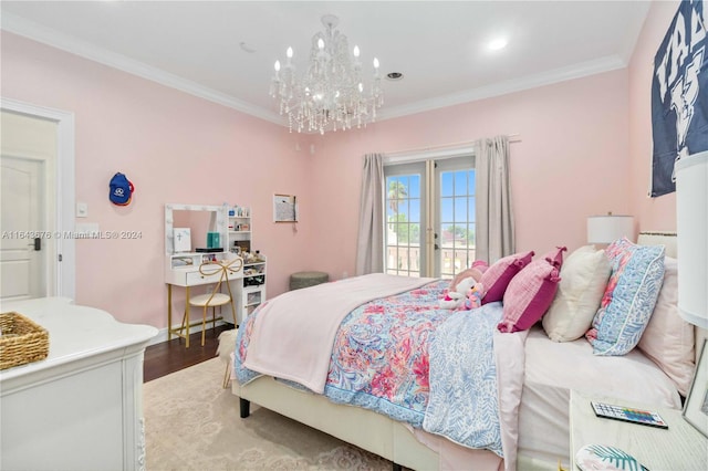 bedroom featuring ornamental molding, wood-type flooring, a notable chandelier, and access to outside