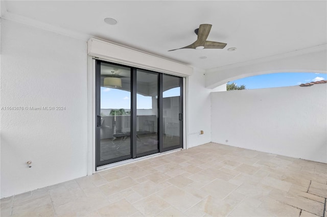 unfurnished room with ceiling fan and ornamental molding