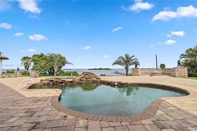 view of swimming pool with a water view and a patio area