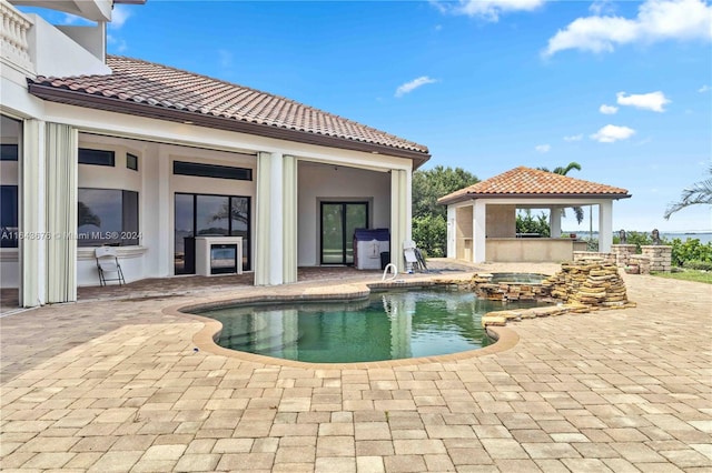 view of swimming pool with a patio area and a gazebo