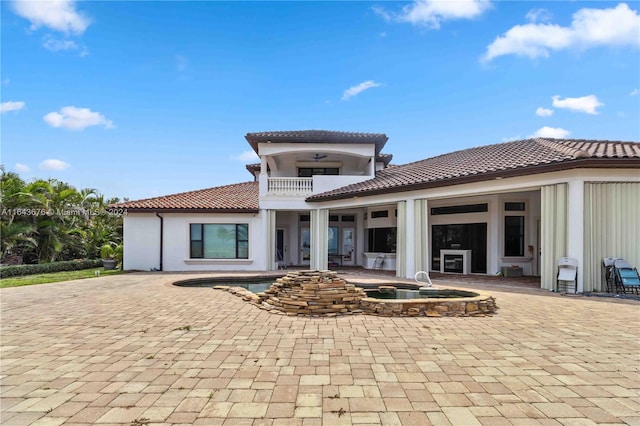 rear view of property with a balcony and a patio