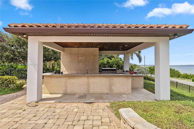 view of patio featuring area for grilling, a gazebo, and exterior bar