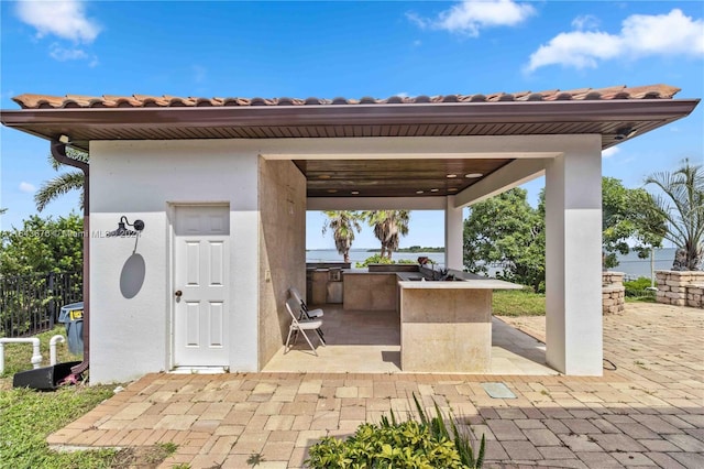 view of patio / terrace with an outdoor kitchen and exterior bar