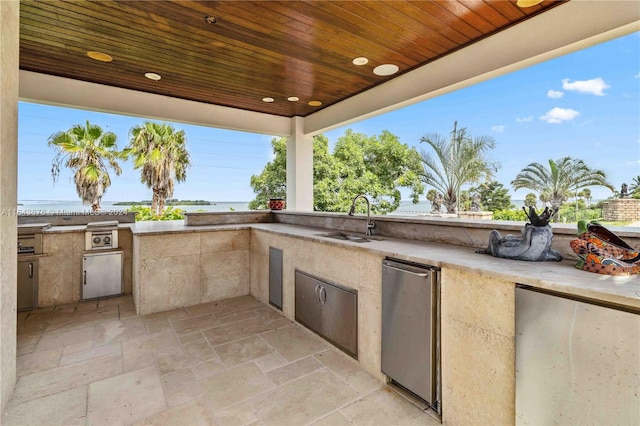 view of patio with area for grilling and sink