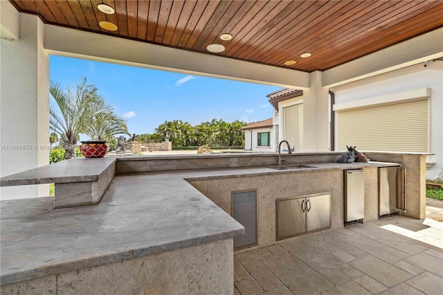 view of patio / terrace featuring area for grilling and sink