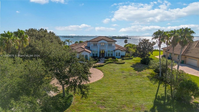 view of yard with a water view and a garage