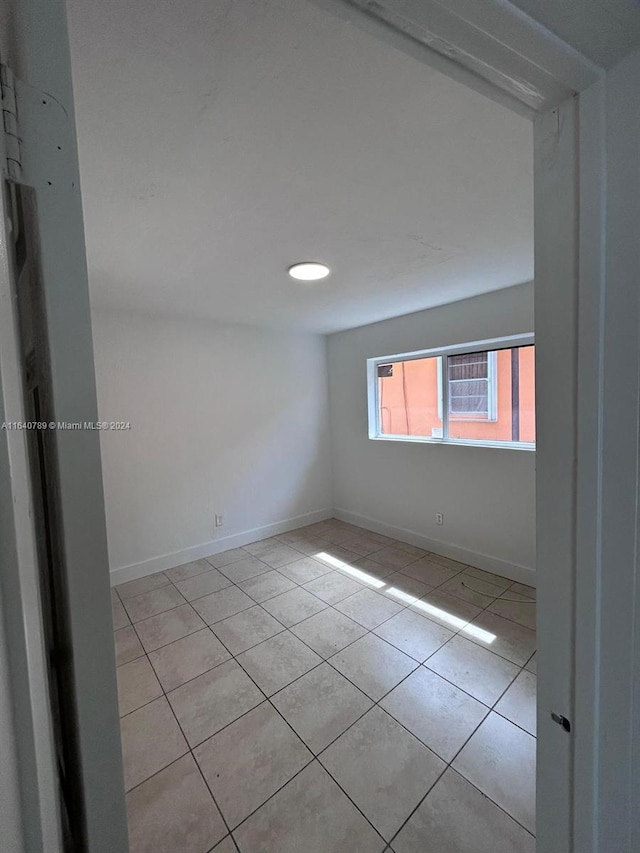 1128 NW 76th St, Miami, FL 33150 - empty room featuring baseboards and light tile patterned floors