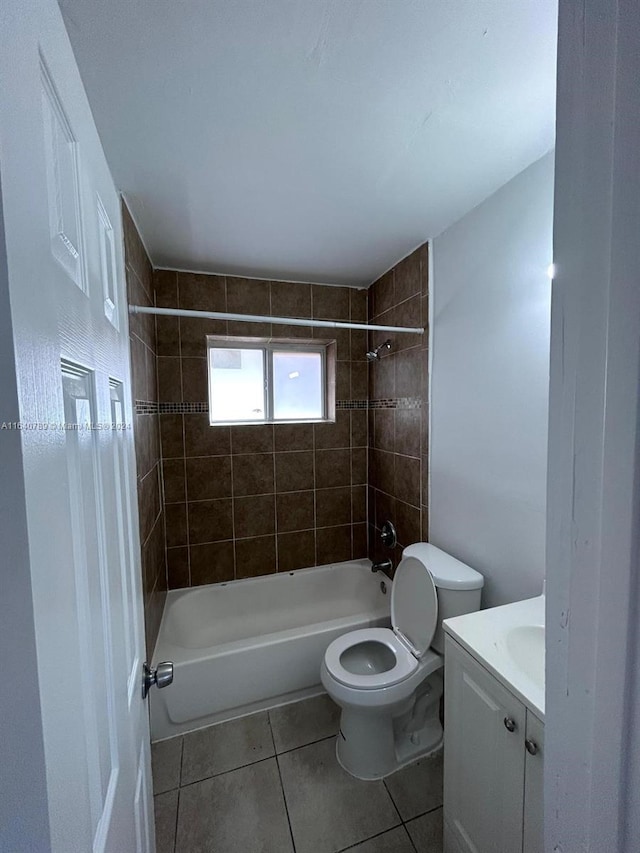 full bathroom with tile patterned flooring, toilet, vanity, and tiled shower / bath