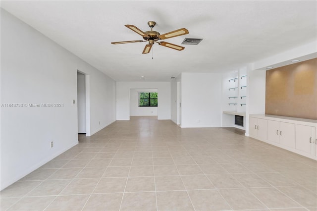 unfurnished living room with ceiling fan and light tile patterned floors