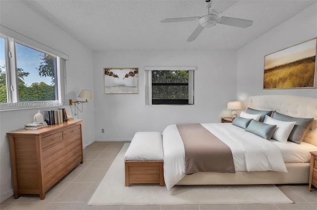 tiled bedroom featuring ceiling fan