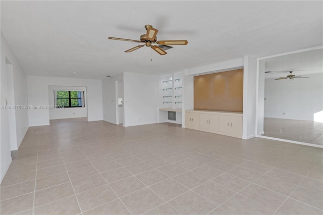 unfurnished living room with ceiling fan and light tile patterned floors