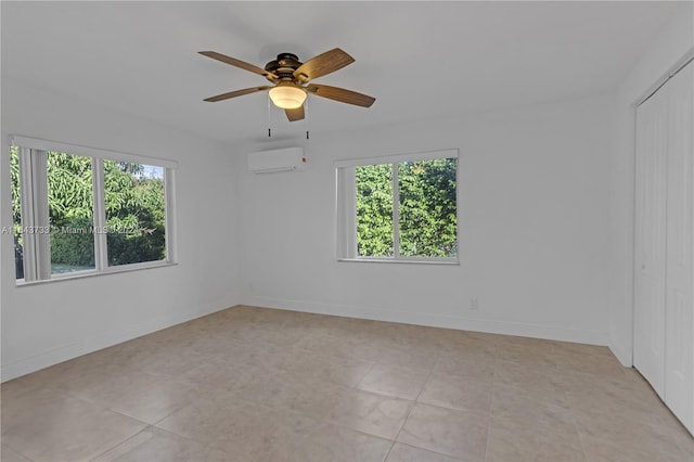 interior space featuring ceiling fan, multiple windows, light tile patterned floors, and an AC wall unit