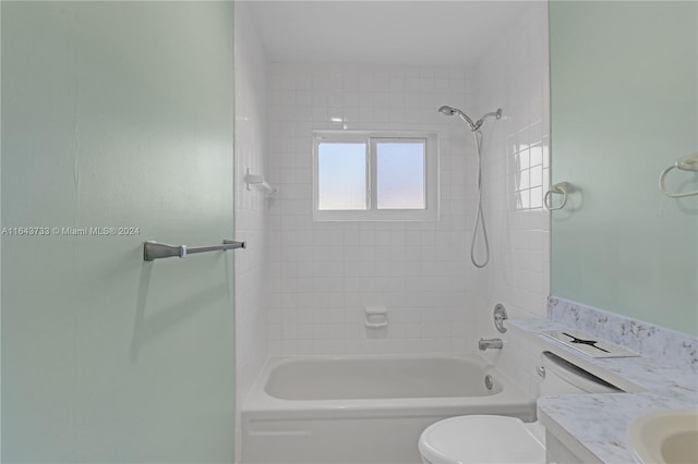 full bathroom with toilet, tiled shower / bath, and vanity