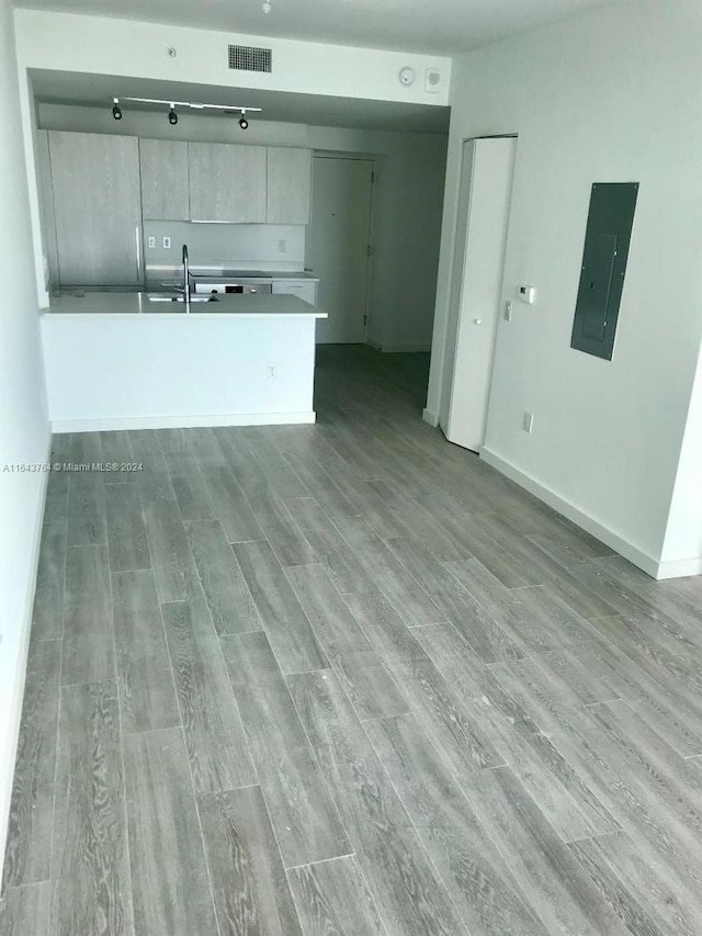 kitchen featuring sink, hardwood / wood-style floors, and electric panel