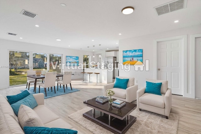 living room with light hardwood / wood-style flooring