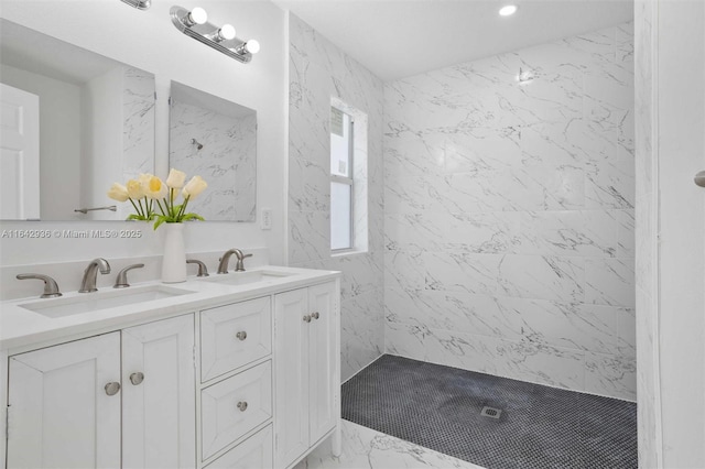 bathroom featuring tiled shower and vanity