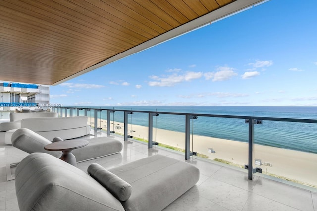 balcony with a water view and a beach view