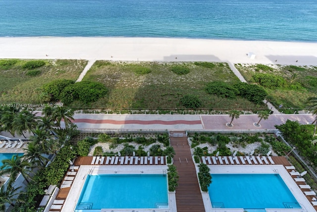 drone / aerial view with a view of the beach and a water view