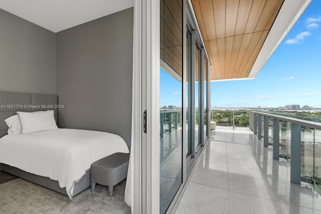 bedroom with expansive windows and access to exterior