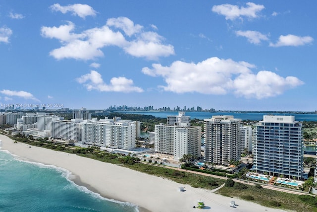 aerial view with a water view and a beach view