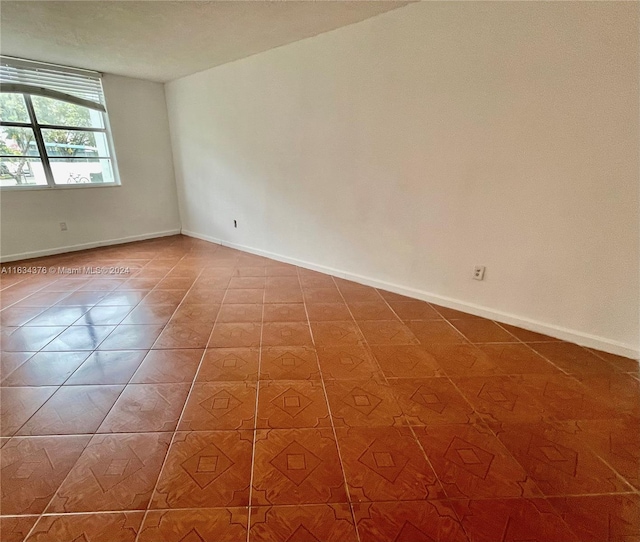 spare room featuring tile patterned flooring