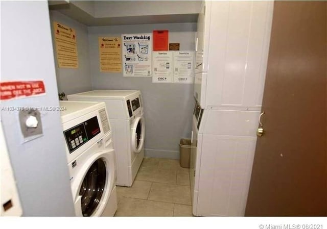 washroom with stacked washing maching and dryer, washing machine and dryer, and light tile patterned flooring