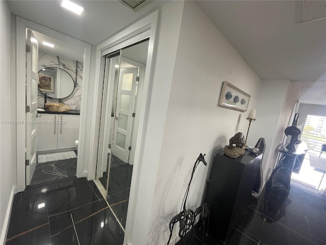 hallway with tile patterned floors