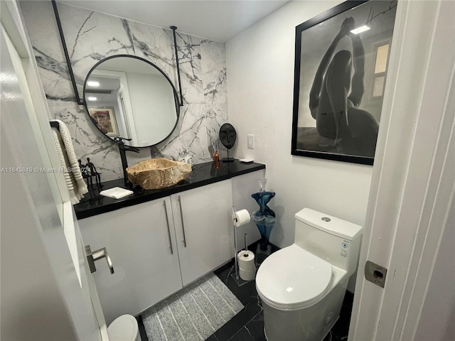 bathroom with tile patterned floors, vanity, and toilet