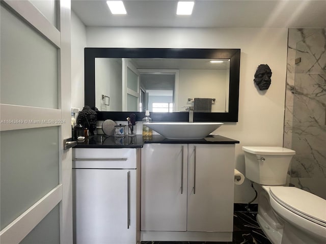 bathroom featuring toilet and vanity