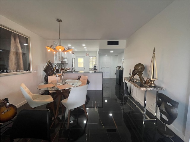 dining space with dark tile patterned floors