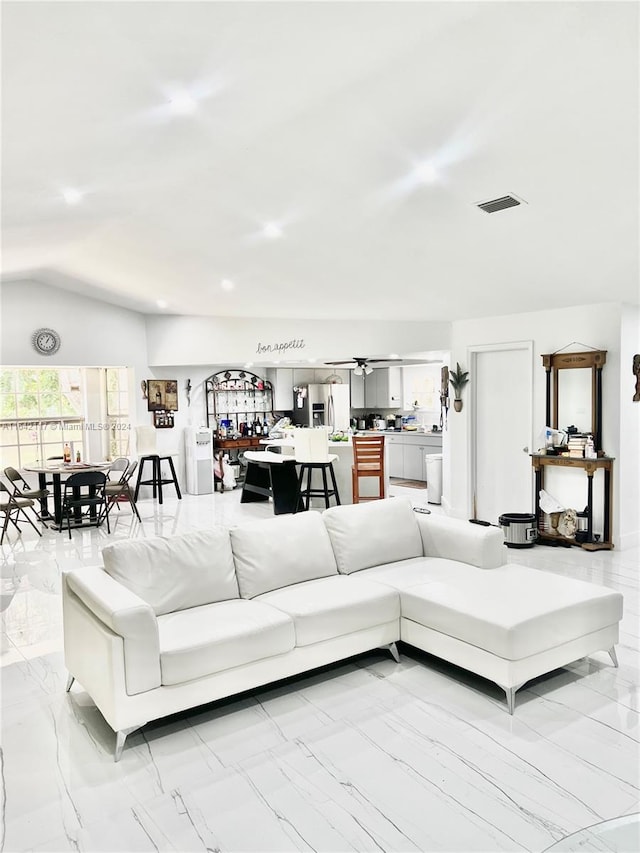 tiled living room featuring lofted ceiling