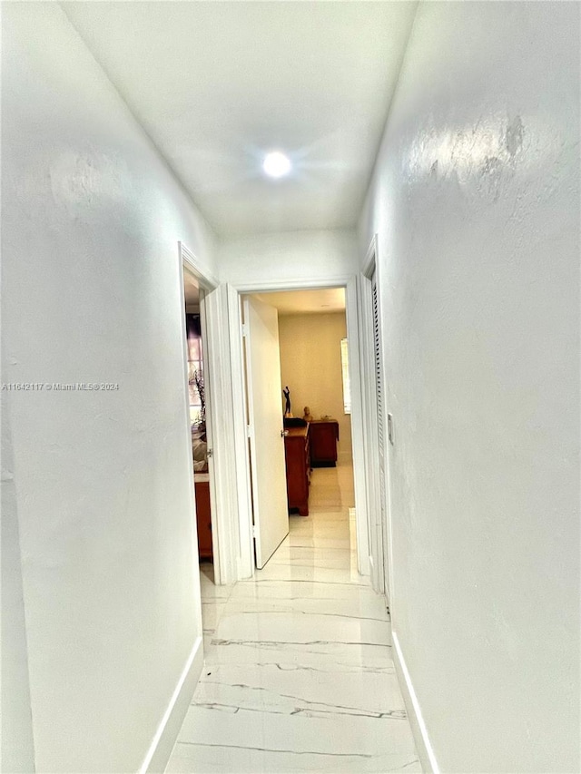 corridor with light hardwood / wood-style flooring