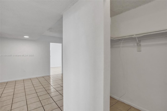 spacious closet featuring light tile patterned flooring