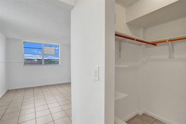 walk in closet featuring light tile patterned flooring