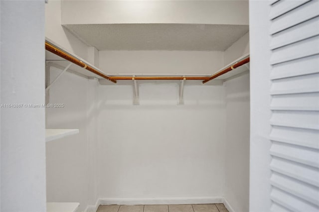 spacious closet featuring light tile patterned flooring