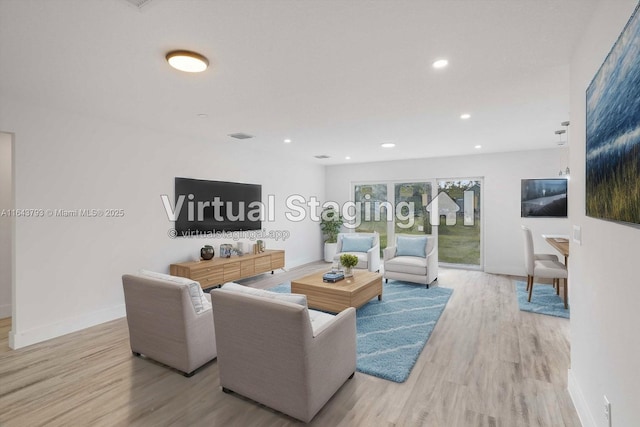 living room with light hardwood / wood-style flooring