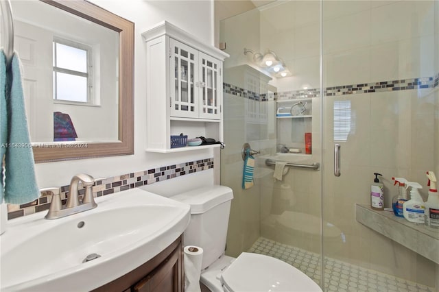 bathroom featuring toilet, walk in shower, vanity, and tile walls