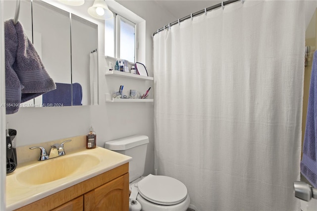 bathroom featuring toilet and vanity