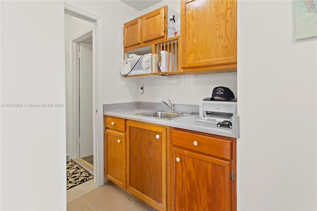 kitchen with sink and light tile patterned flooring