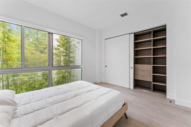 bedroom featuring a closet and light wood-type flooring