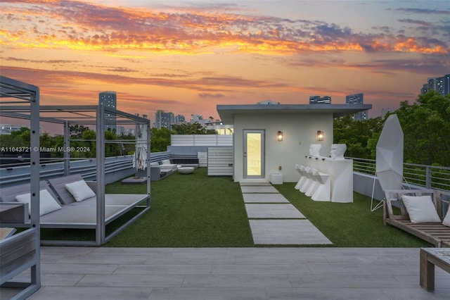 yard at dusk featuring a patio area