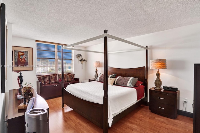 bedroom featuring a textured ceiling and hardwood / wood-style flooring